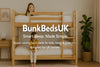 Two smiling children on a wooden bunk bed in a cosy UK bedroom – BunkBedsUK About Us